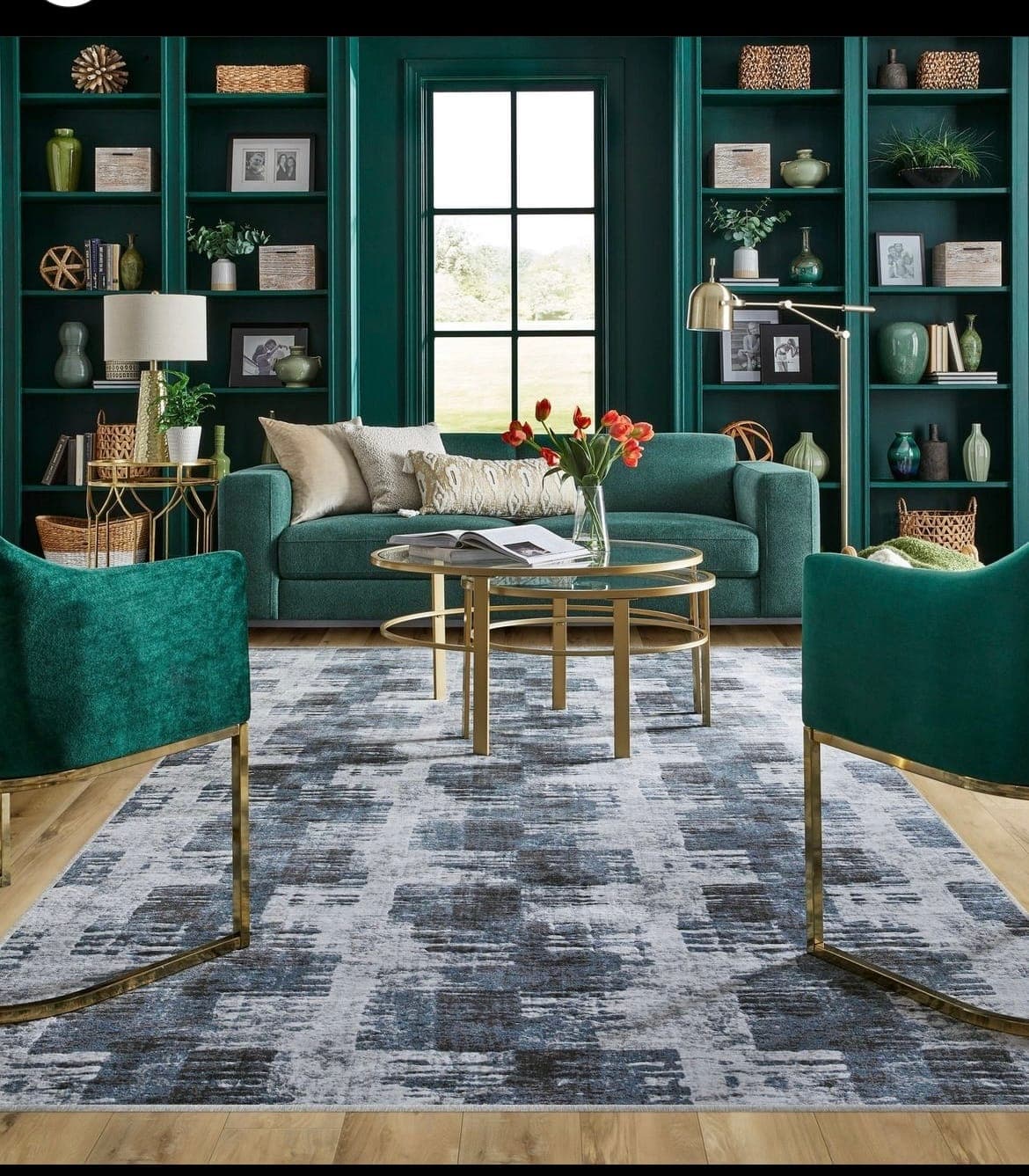 Richly styled sitting room with large windows, layered window treatments, and an area rug
