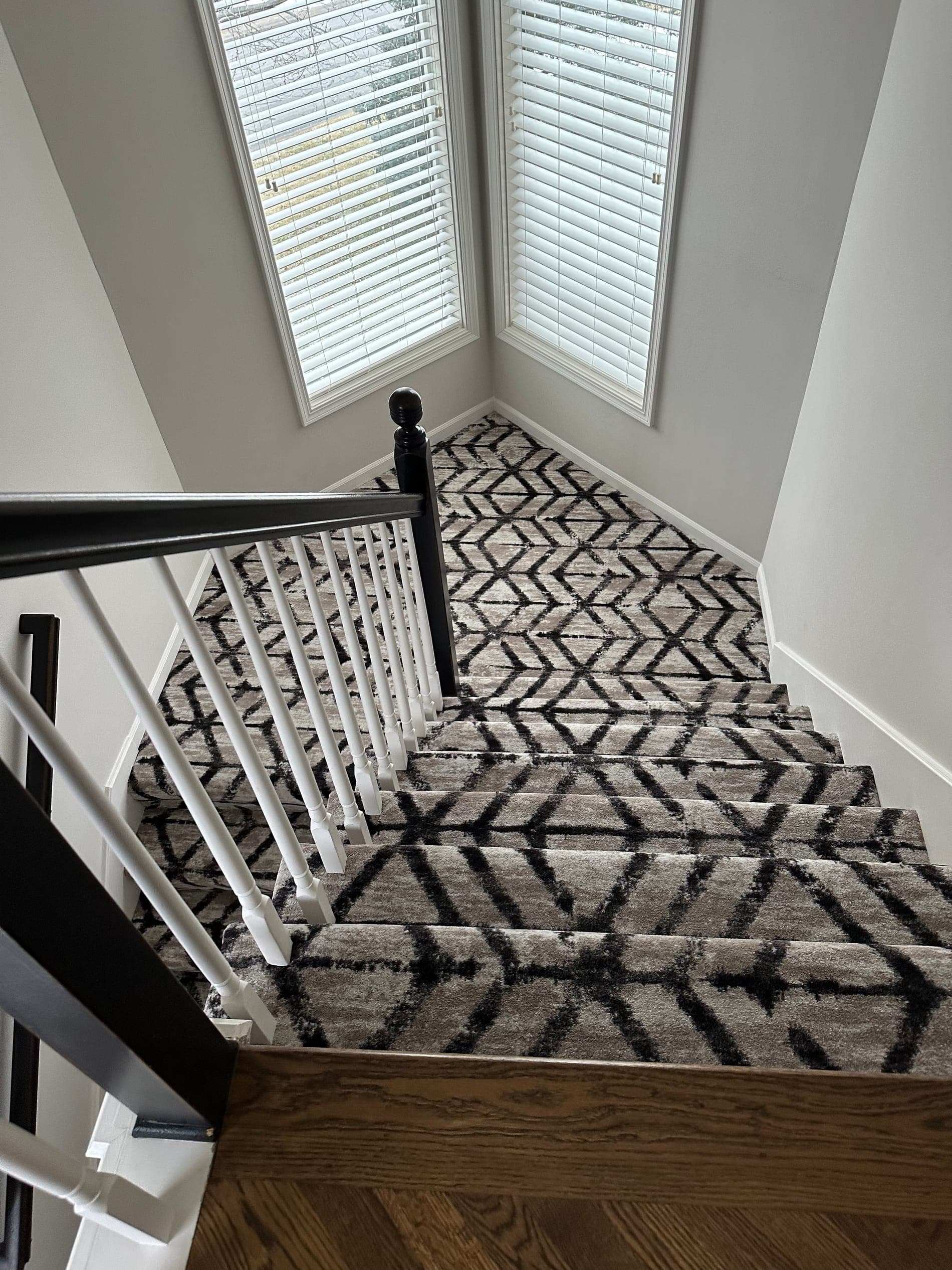 Curved staircase dressed in a custom-fit runner
